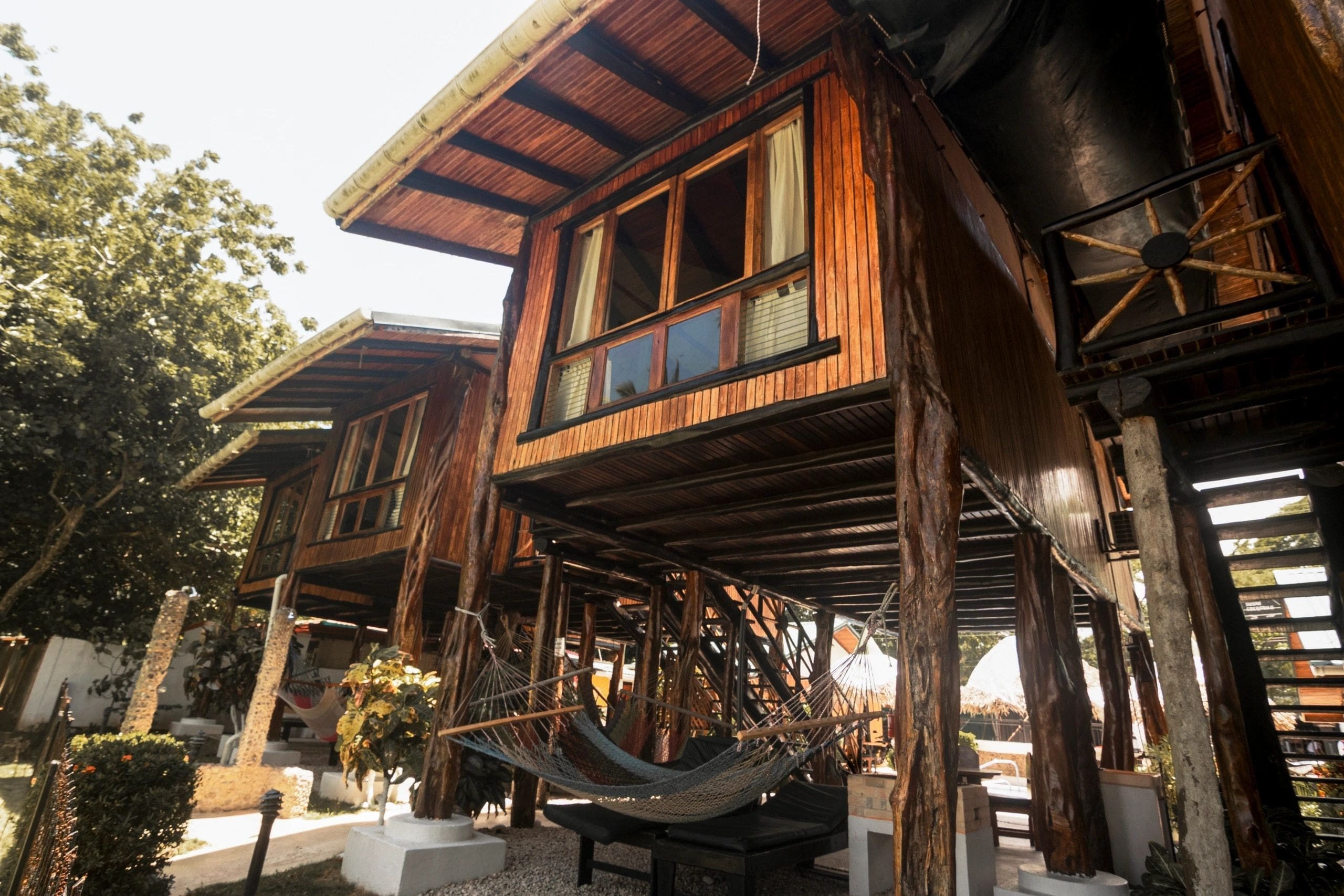 A wooden structure with a hammock in front of it.