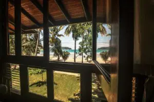 A view of the beach from inside a house.