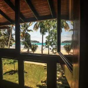 A view of the beach from inside a house.