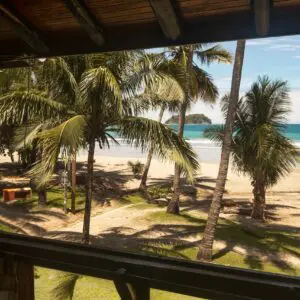 A view of the beach from inside a house.