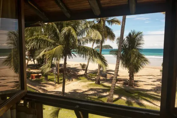 A view of the beach from inside a house.