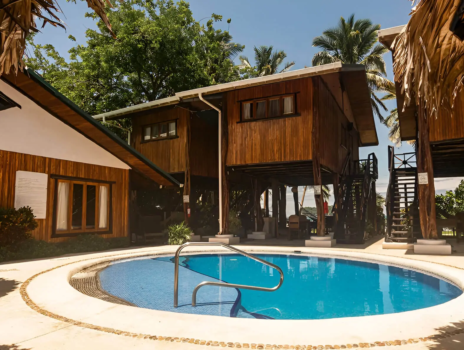 A pool with a wooden structure in the background.