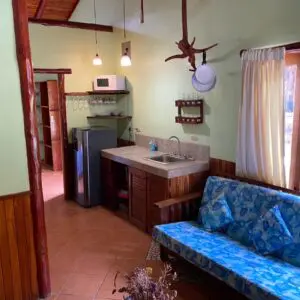 A kitchen with a blue couch and sink