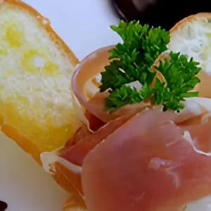 A plate of food with bread and meat.