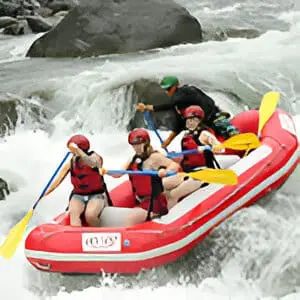 A group of people in a raft on the water.