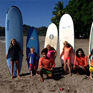 A group of people standing on top of a beach.