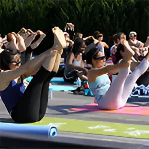 A group of people doing yoga on the ground.